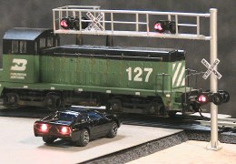 Model railroad crossing signal and crossing gate controllers